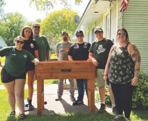 Civic-minded teens build raised bed for disabled