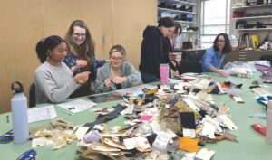 College students exploring historic clothing in J-term