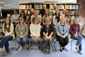 School employees pose for a picture in a school library.