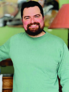 head shot of a man with a beard and green shirt