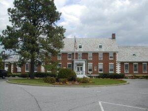 Porter shares in hospital budget cuts, layoffs