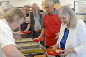 Get out, rub elbows with neighbors and enjoy a community meal