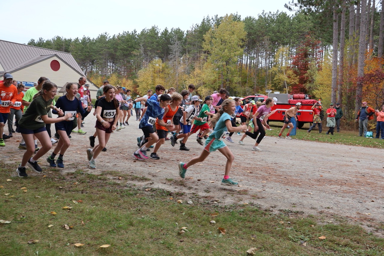 Ripton Ridge racers run under red, orange and yellow leaves